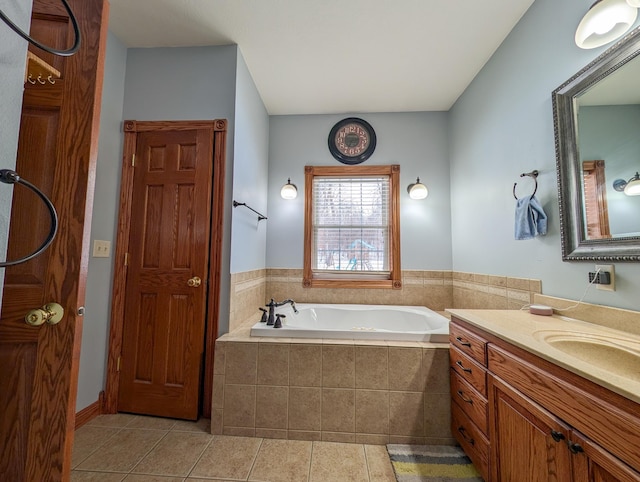 bathroom with vanity, a relaxing tiled tub, and tile patterned floors