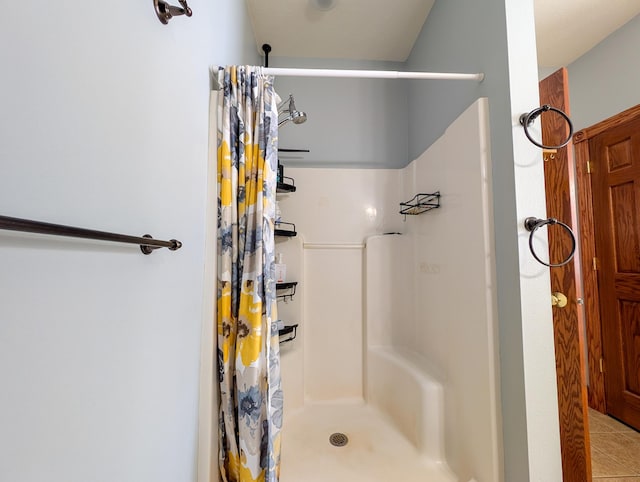 bathroom with walk in shower and tile patterned flooring