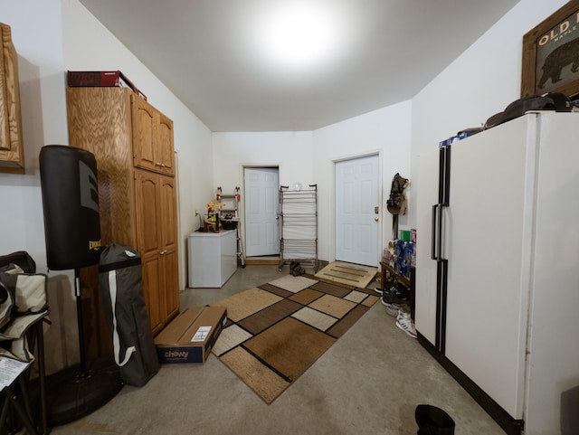 garage with washer / dryer and white fridge