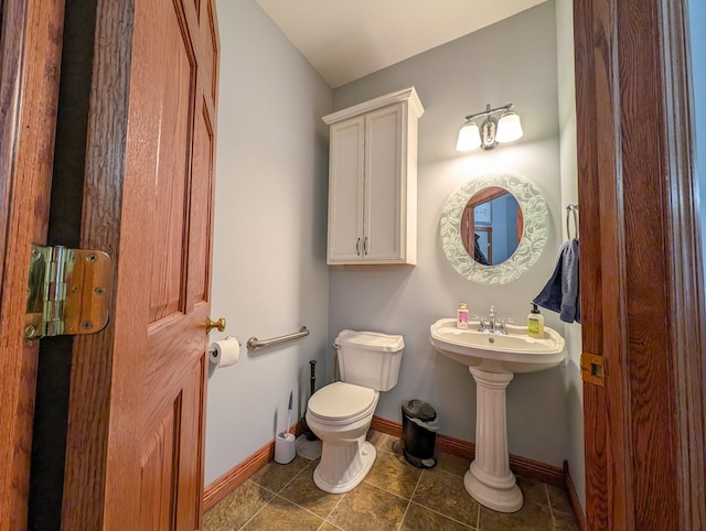 bathroom with toilet and tile patterned flooring