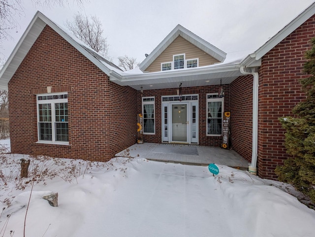 view of snow covered property entrance