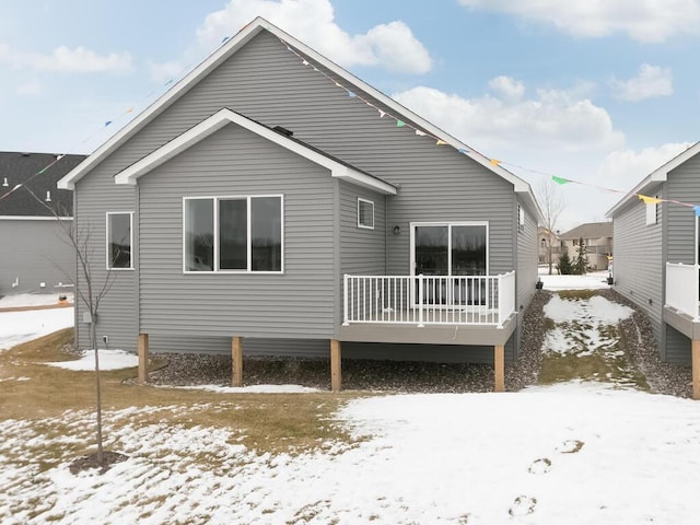 view of snow covered rear of property