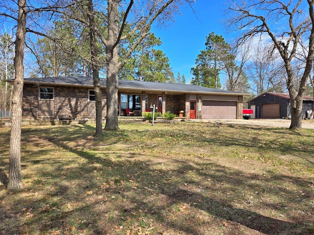 ranch-style house with brick siding, an attached garage, driveway, and a front lawn
