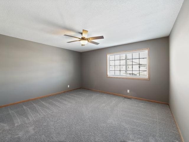 unfurnished room featuring a textured ceiling and carpet flooring