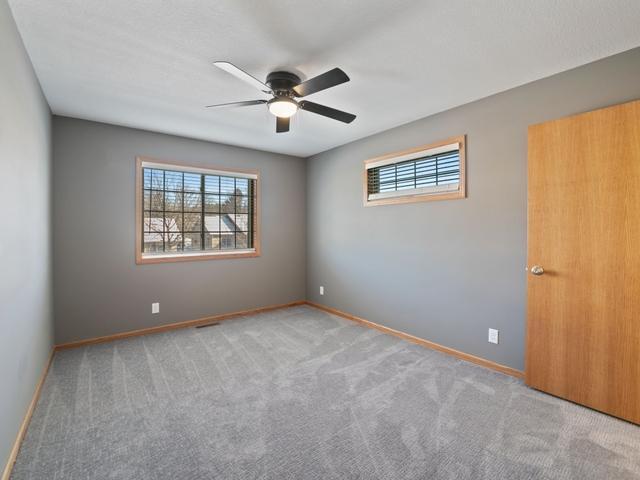 spare room with ceiling fan and carpet flooring