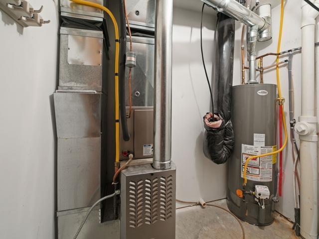 utilities featuring heating unit and gas water heater