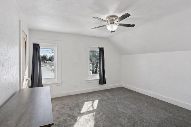 additional living space featuring lofted ceiling, baseboards, carpet floors, and ceiling fan