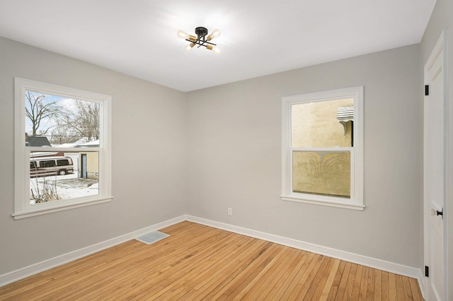 empty room with light hardwood / wood-style floors