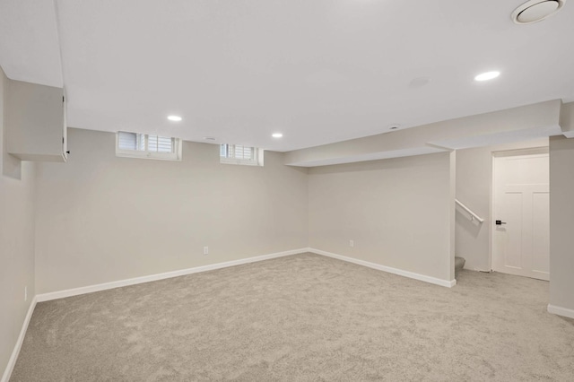 basement featuring light colored carpet