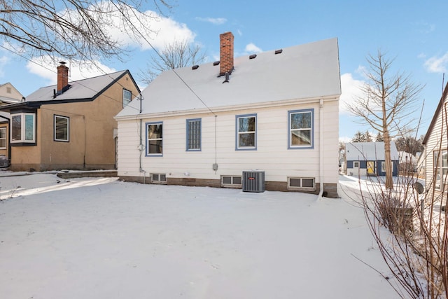 snow covered back of property with central AC unit