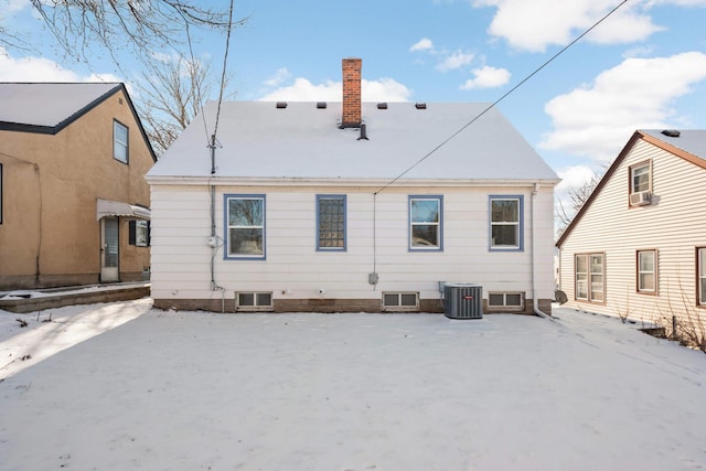 snow covered back of property with cooling unit