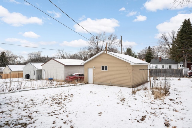 view of snow covered back of property