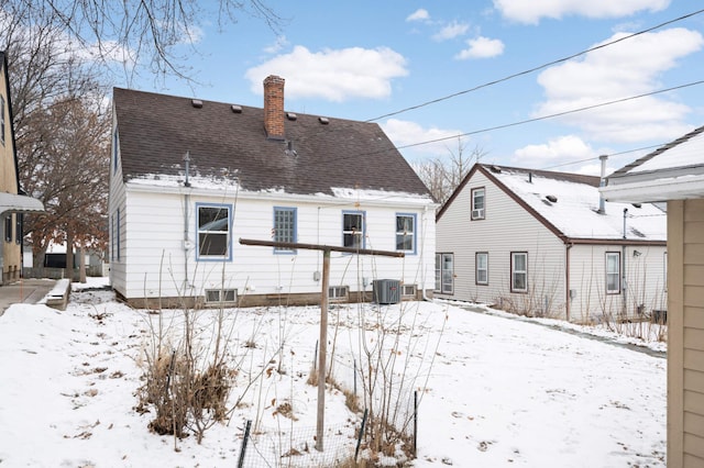 snow covered property with central air condition unit