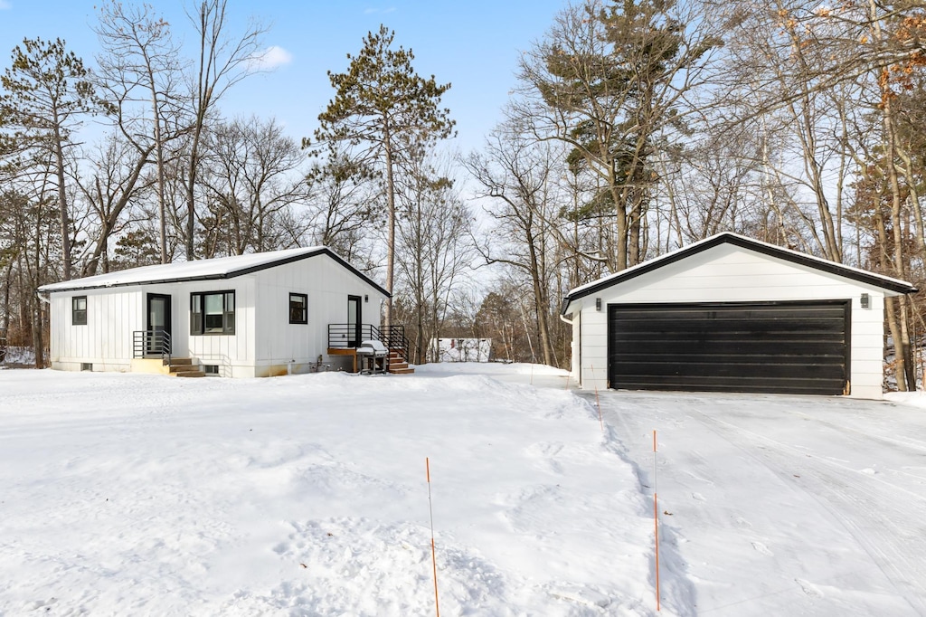 view of snowy exterior featuring a garage