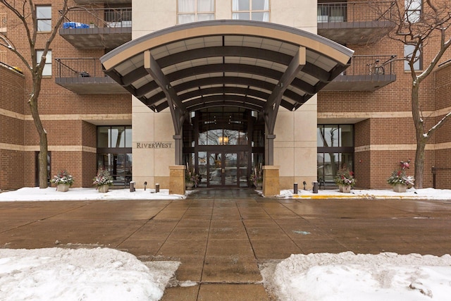 view of snow covered property entrance