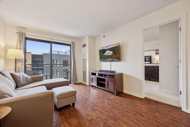 living room featuring dark hardwood / wood-style floors and a textured ceiling