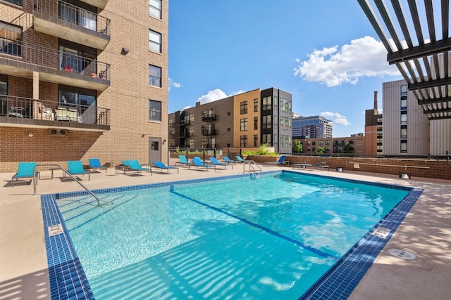 view of swimming pool featuring a pergola and a patio area