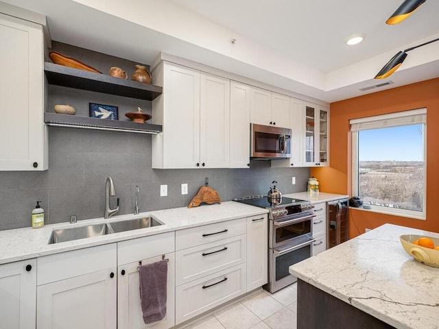 kitchen featuring appliances with stainless steel finishes, sink, and white cabinets