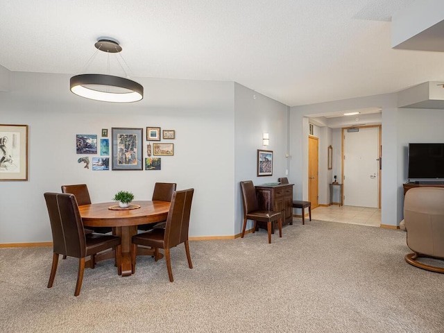 dining area with light colored carpet