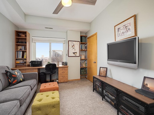 home office with ceiling fan and light carpet