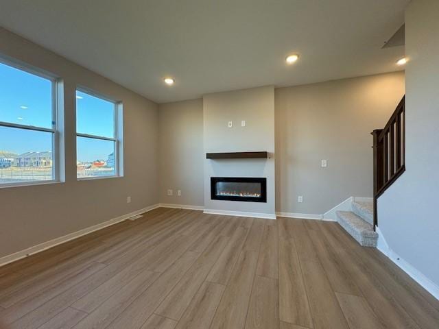 unfurnished living room with light hardwood / wood-style floors