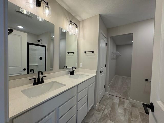 bathroom featuring an enclosed shower and vanity