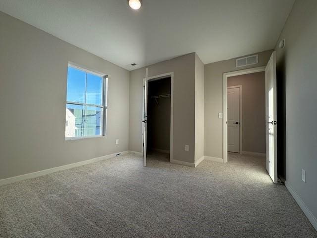 unfurnished bedroom with a closet and carpet