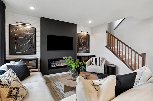 living room with light hardwood / wood-style floors and a fireplace