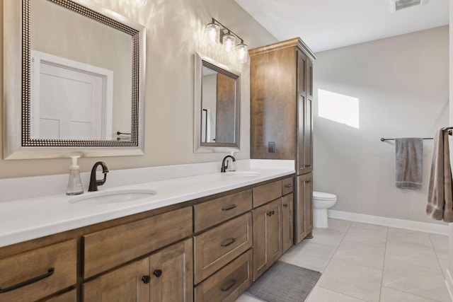 bathroom with tile patterned floors, vanity, and toilet