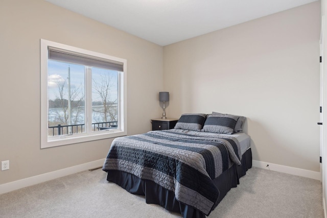 bedroom featuring light carpet