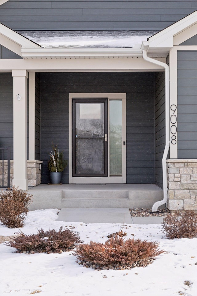 view of snow covered property entrance