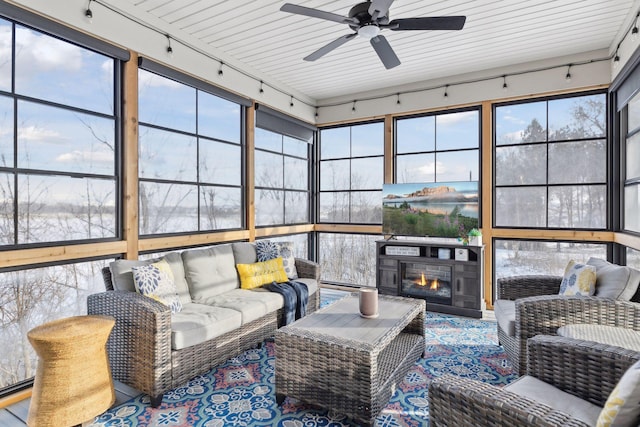 sunroom / solarium featuring ceiling fan and wooden ceiling