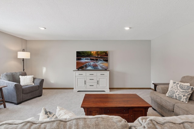 living room with a textured ceiling and light carpet