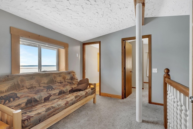 carpeted living room featuring a textured ceiling, a water view, and lofted ceiling