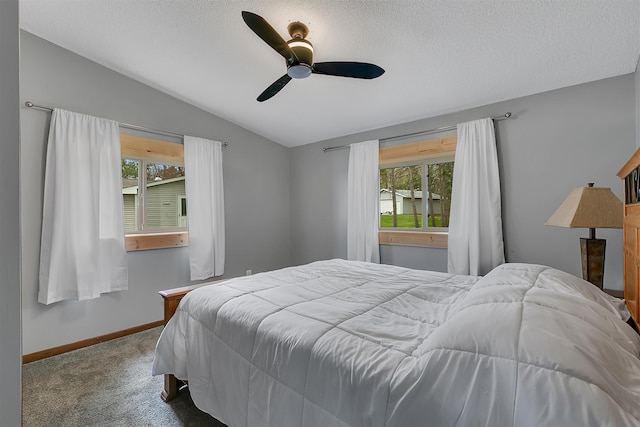 bedroom with lofted ceiling, carpet floors, ceiling fan, and a textured ceiling