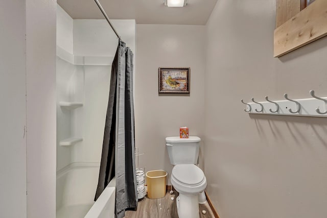 bathroom with toilet and wood-type flooring