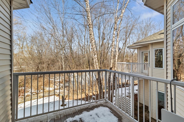 view of snow covered back of property