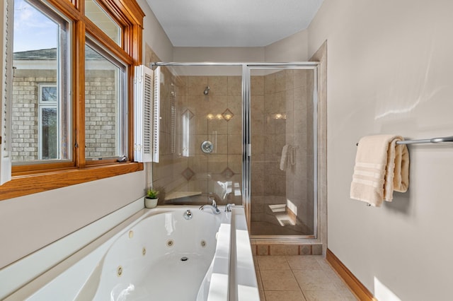 full bath featuring baseboards, a jetted tub, a stall shower, and tile patterned flooring