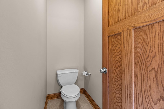 bathroom featuring tile patterned floors, toilet, and baseboards