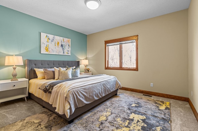 bedroom featuring a textured ceiling, carpet, visible vents, and baseboards