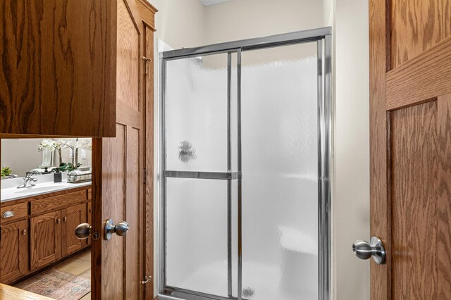 full bath featuring vanity and a shower stall