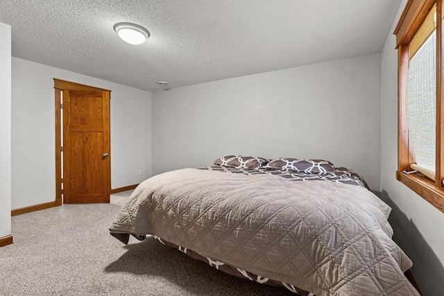 bedroom featuring a textured ceiling and baseboards