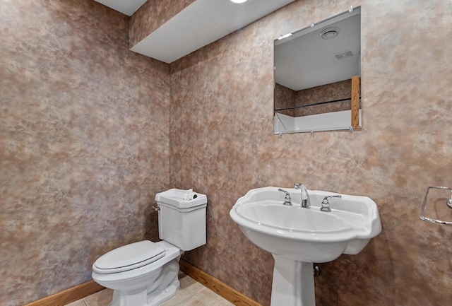 bathroom with visible vents, baseboards, toilet, and tile patterned flooring