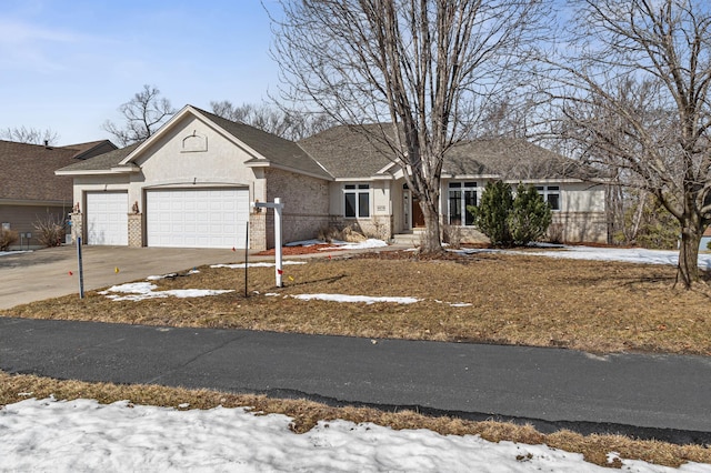 single story home with brick siding, concrete driveway, and an attached garage