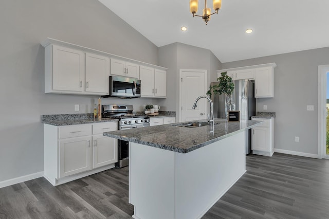 kitchen featuring stainless steel appliances, sink, white cabinetry, lofted ceiling, and dark wood-type flooring