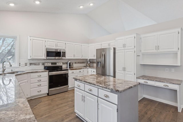 kitchen with sink, a center island, white cabinets, and appliances with stainless steel finishes