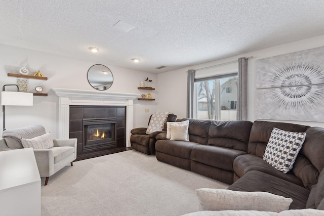 living room with a fireplace and a textured ceiling