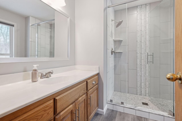 bathroom featuring wood-type flooring, walk in shower, and vanity