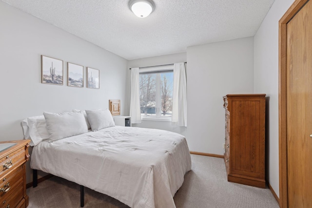 carpeted bedroom featuring a textured ceiling