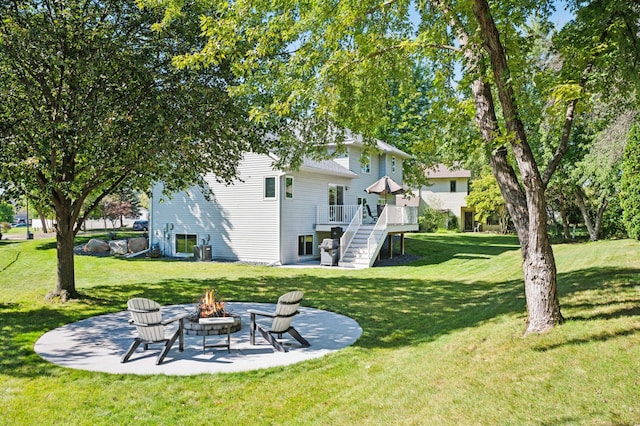 view of yard with a wooden deck, a patio area, and an outdoor fire pit